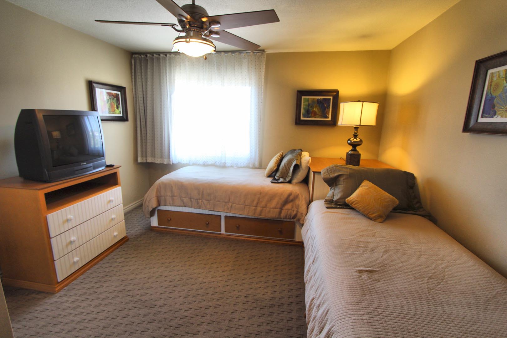 A bedroom with double beds at VRI's Four Seasons Pacifica in San Clemente, California.